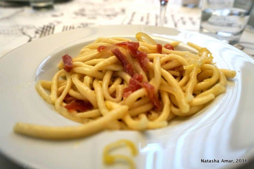 strozzapretti pasta in Bologna, Italy. Love Italian food? Take a cooking class in Italy where you'll learn to prepare classic pasta dishes and taste as well. This is a bucketlist worthy experience for foodies traveling to Italy. #Italytravel #Italycookingclass