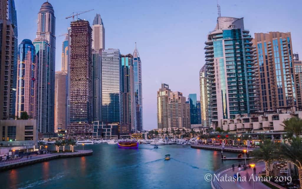 Dubai Marina with skyscrapers rising on both sides of a canal 