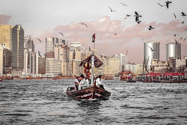 People ride the old Dubai creek on a traditional wooden boat called abra.
