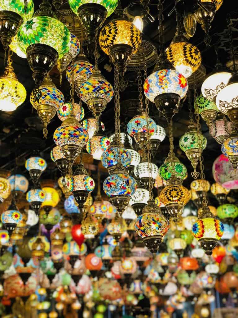 Colorful Arabic-style globe lamps hang in a shop display