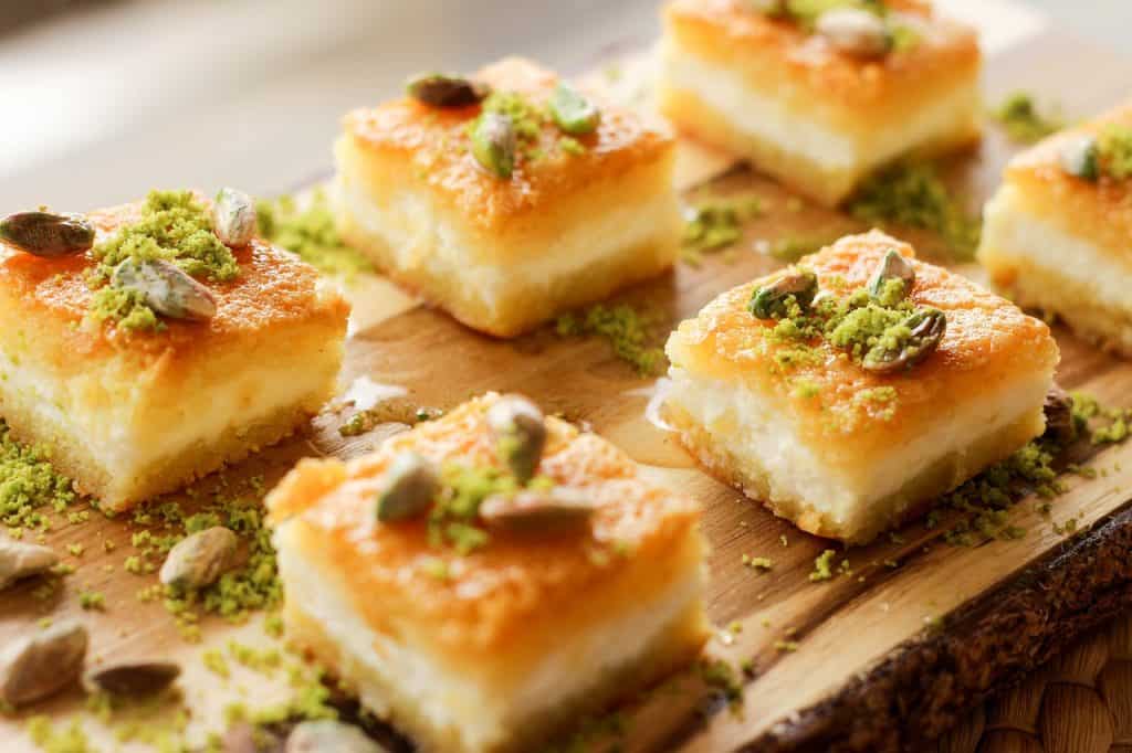 Pieces of golden baklava topped with pistachios