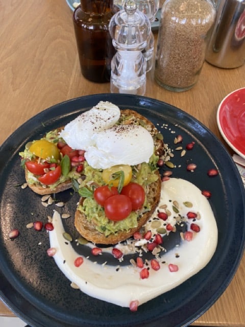 Poached eggs on avocado at Friends Avenue Cafe